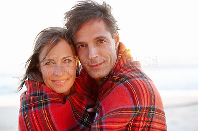 Buy stock photo Hug, blanket or couple at sea for portrait or love on vacation, anniversary or honeymoon holiday. Winter, cold or people with smile on date at beach together for travel, bonding or ocean in Spain