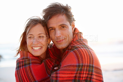 Buy stock photo Hug, blanket or couple at beach for portrait or love on vacation, anniversary or honeymoon holiday. Smile, cold or people with smile on date at sea together for travel, bonding or ocean trip in Spain