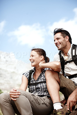 Buy stock photo Two hikers laughing and smiling while enjoying a mountain top view