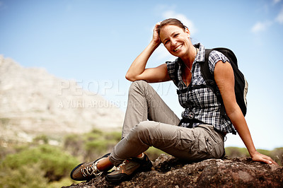 Buy stock photo Attractive female hiker smiling while resting on a mountain top