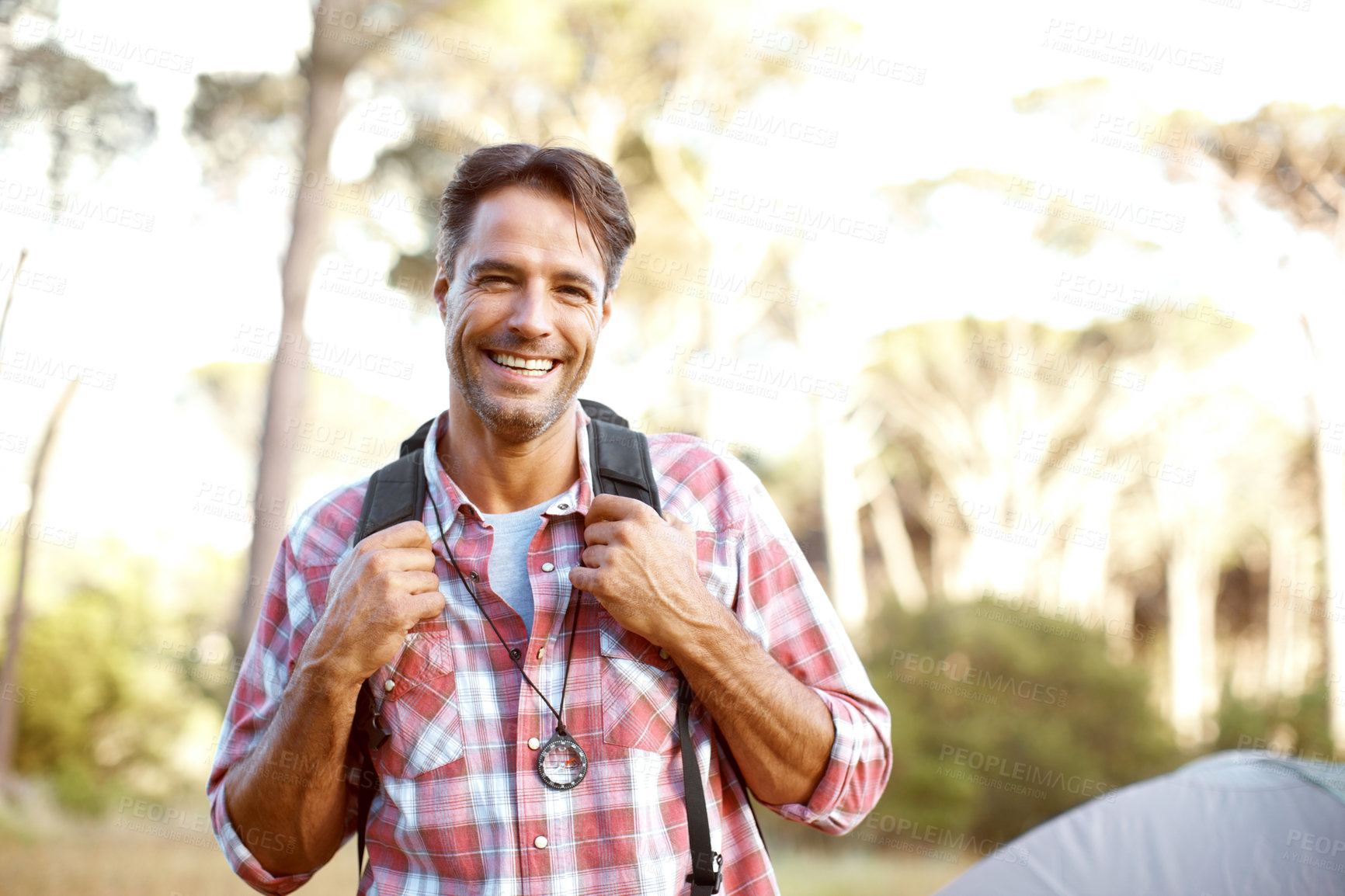 Buy stock photo Man, portrait and backpack by tent for camping, outdoor and smile with pride, adventure and journey in summer. Person, happy and bag with direction, travel and vacation with sunshine in Costa Rica