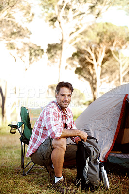 Buy stock photo Portrait of a handsome young man sitting by his tent