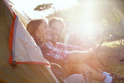 Buy stock photo A young couple sitting by their tent