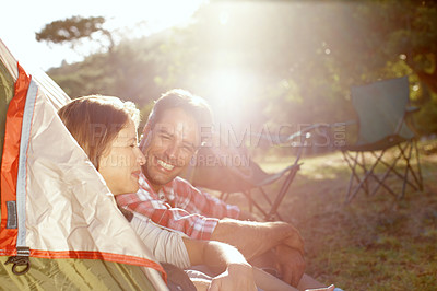 Buy stock photo Outdoor, couple and smile by tent for camping, holiday and travel vacation with bonding in wilderness. Nature, man and woman with admiration for commitment, adventure or love with connection by flare