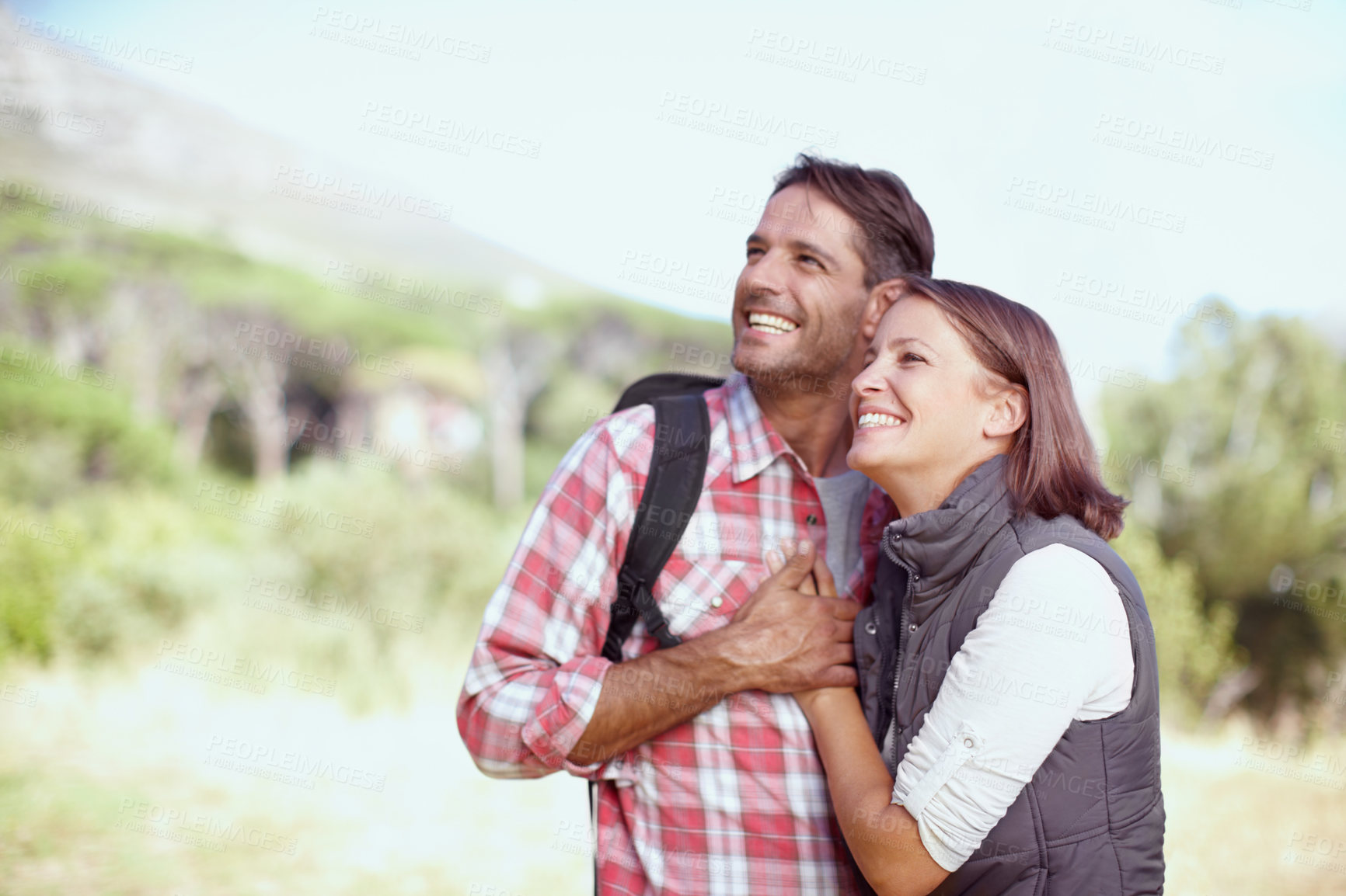 Buy stock photo Hug, view or happy couple in nature for hiking, adventure or fun travel on break in woods. Love, smile or people looking in forest to relax together for holiday vacation or trekking to explore park