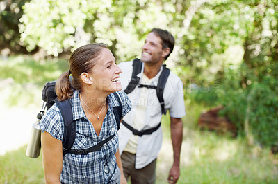 Buy stock photo A young couple enjoying their surroundings while hiking