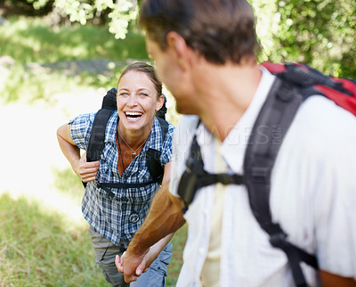 Buy stock photo Couple, happy and holding hands in nature for hiking, fitness and adventure with bonding and support. Man, woman and love outdoor for exercise, health and trekking with journey, travel and walking