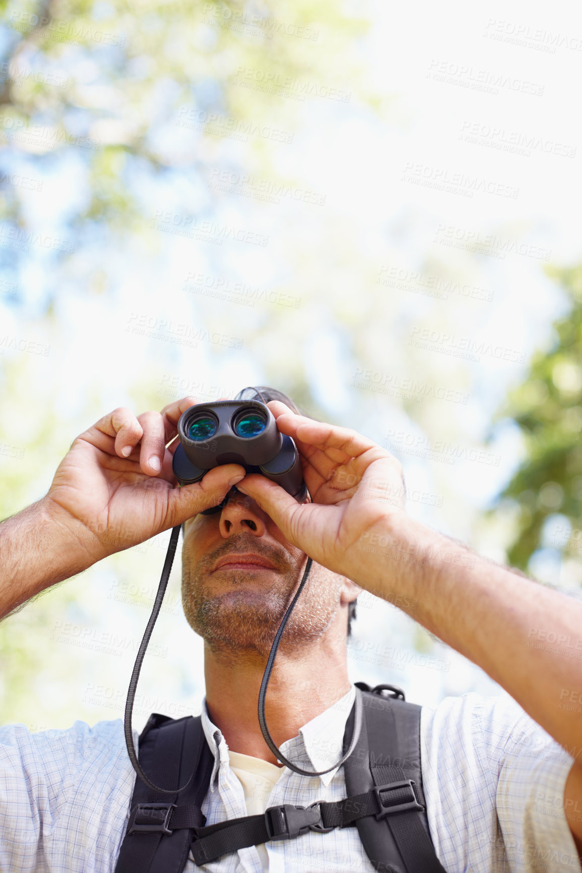 Buy stock photo Man, binoculars and outdoor hiking in nature, tourist adventure and tool for woods discovery. Male person, countryside and glasses for bird watching or sightseeing, hobby and explore wilderness