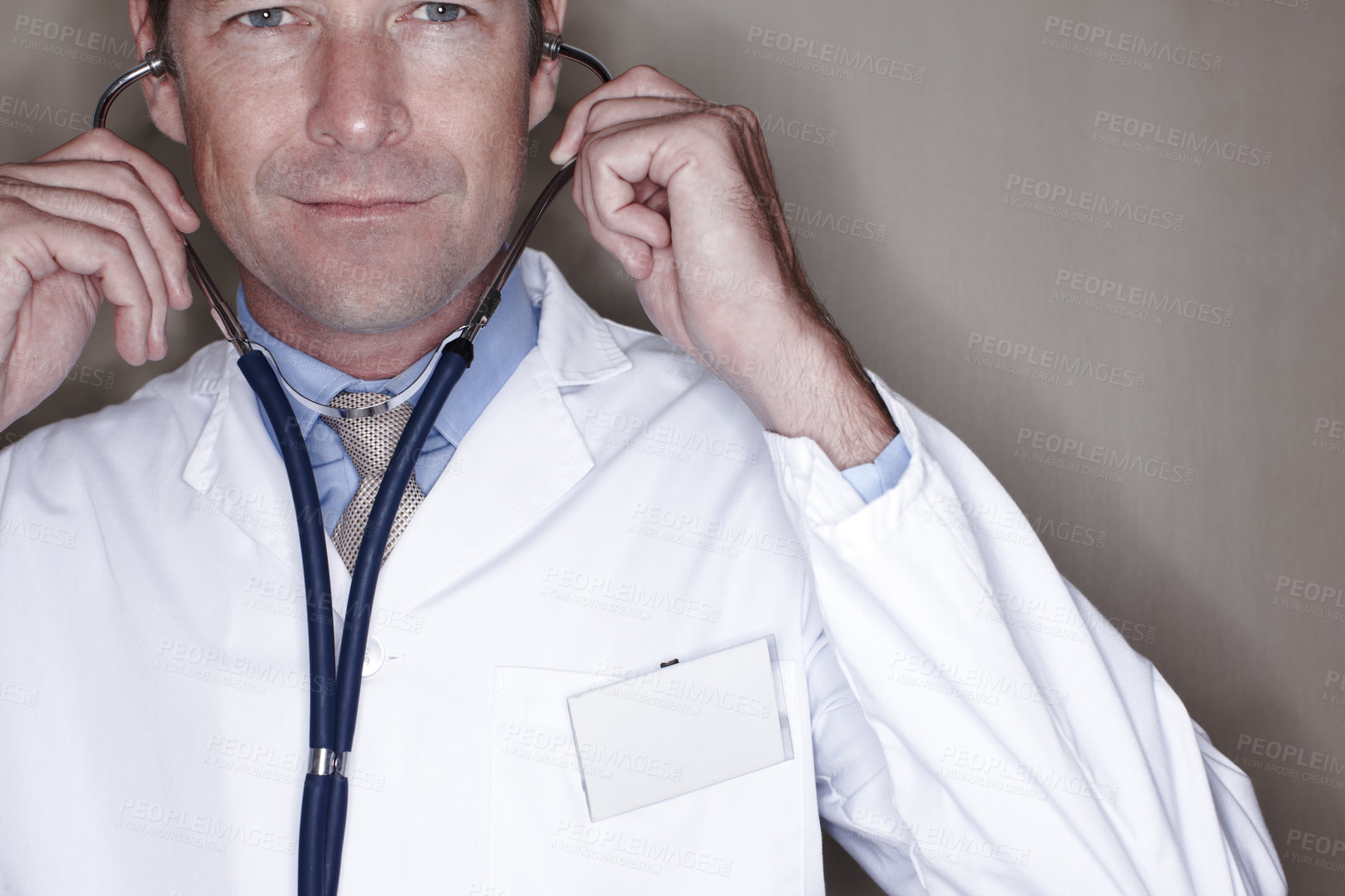 Buy stock photo Portrait, man and doctor with stethoscope in studio background for healthcare, wellness and cardiologist. Mature person, employee and smile as medical profession for heartbeat, evaluation or checkup