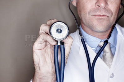 Buy stock photo Man, doctor and hand with stethoscope in studio background for healthcare, consultation and support. Male person, employee and help as medical professional for evaluation, heartbeat and checkup