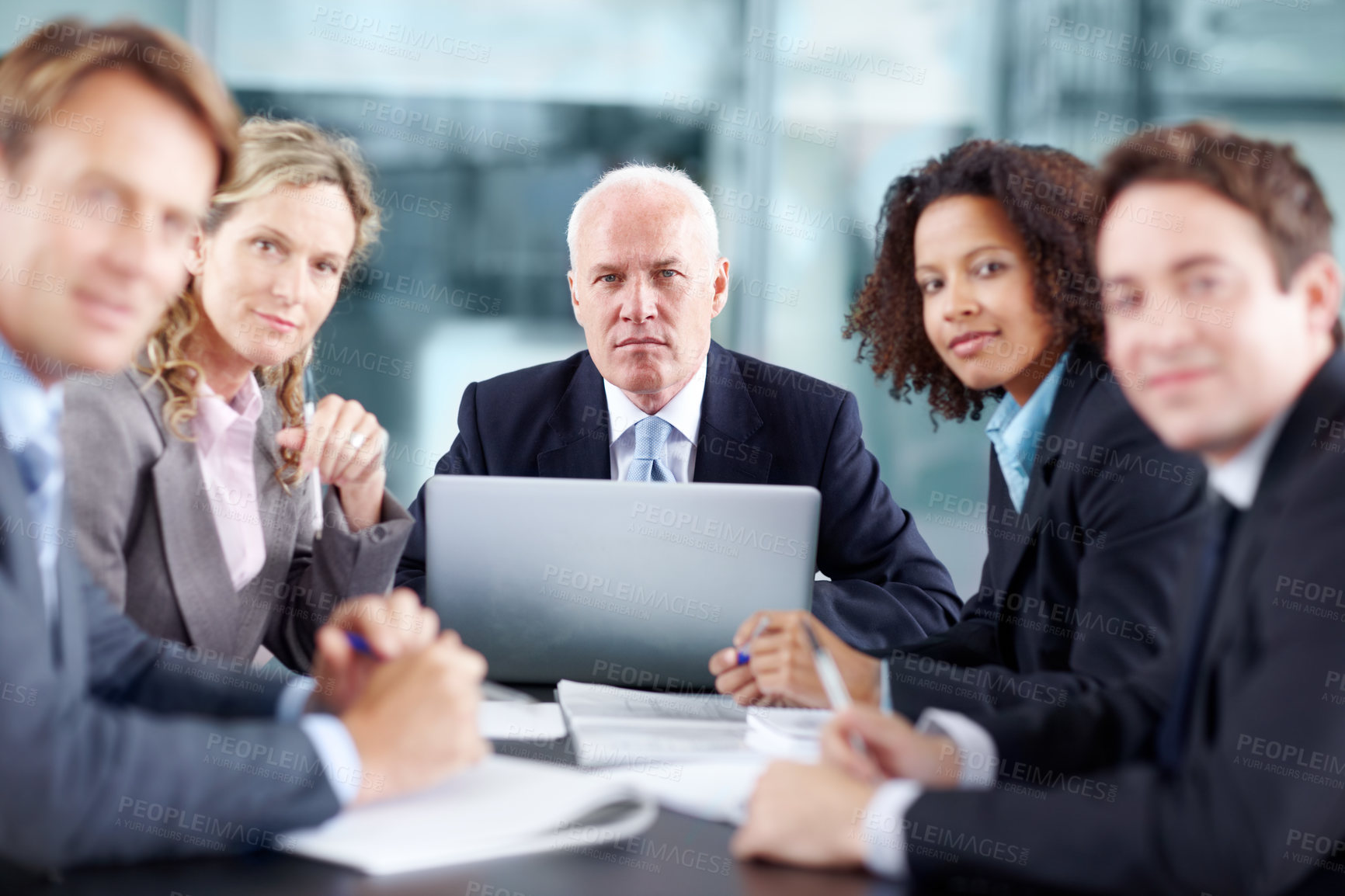 Buy stock photo Business executives sitting at a table during a meeting and using a laptop - portrait