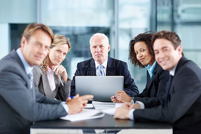 Buy stock photo Corporate coworkers sitting at a table during a meeting and using a laptop - portrait 
