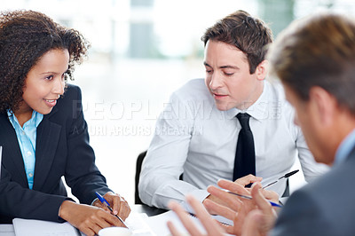 Buy stock photo Inspired and positive business colleagues sitting and having a meeting