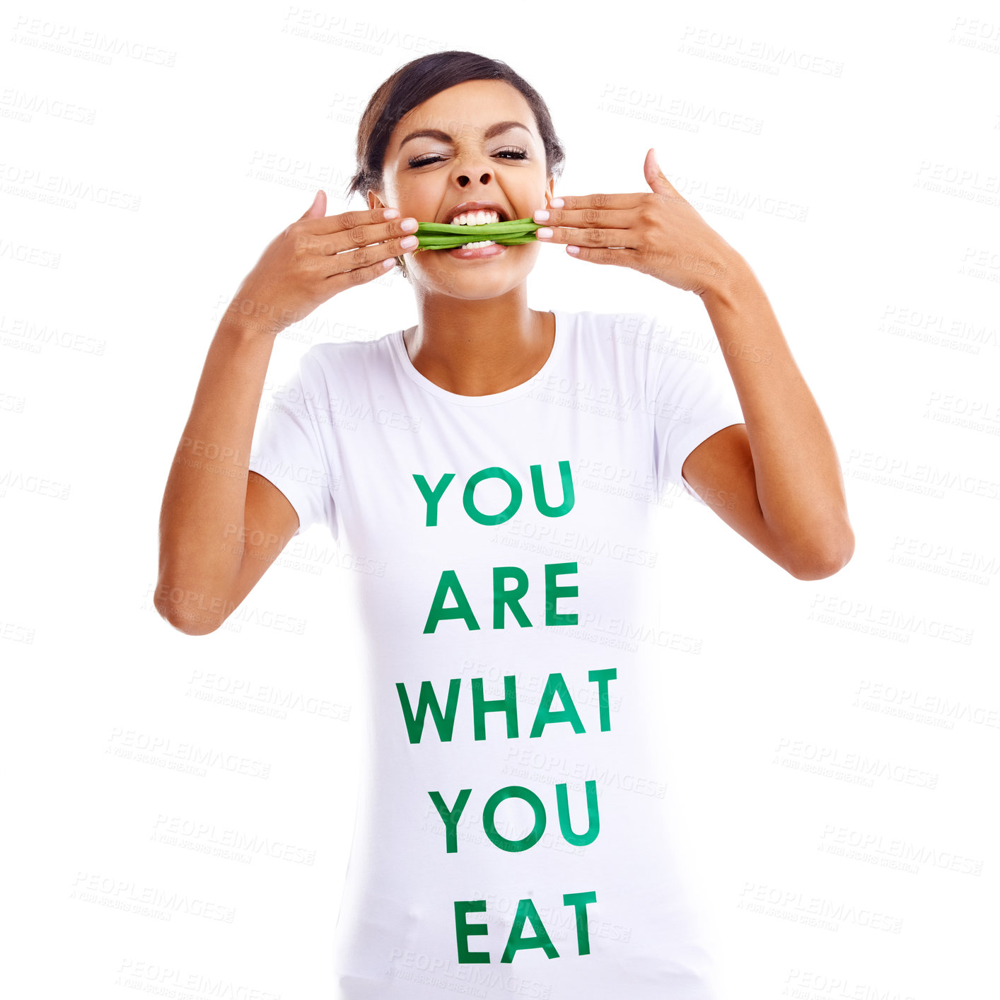 Buy stock photo Portrait of a young woman holding green beans while wearing a t-shirt saying 