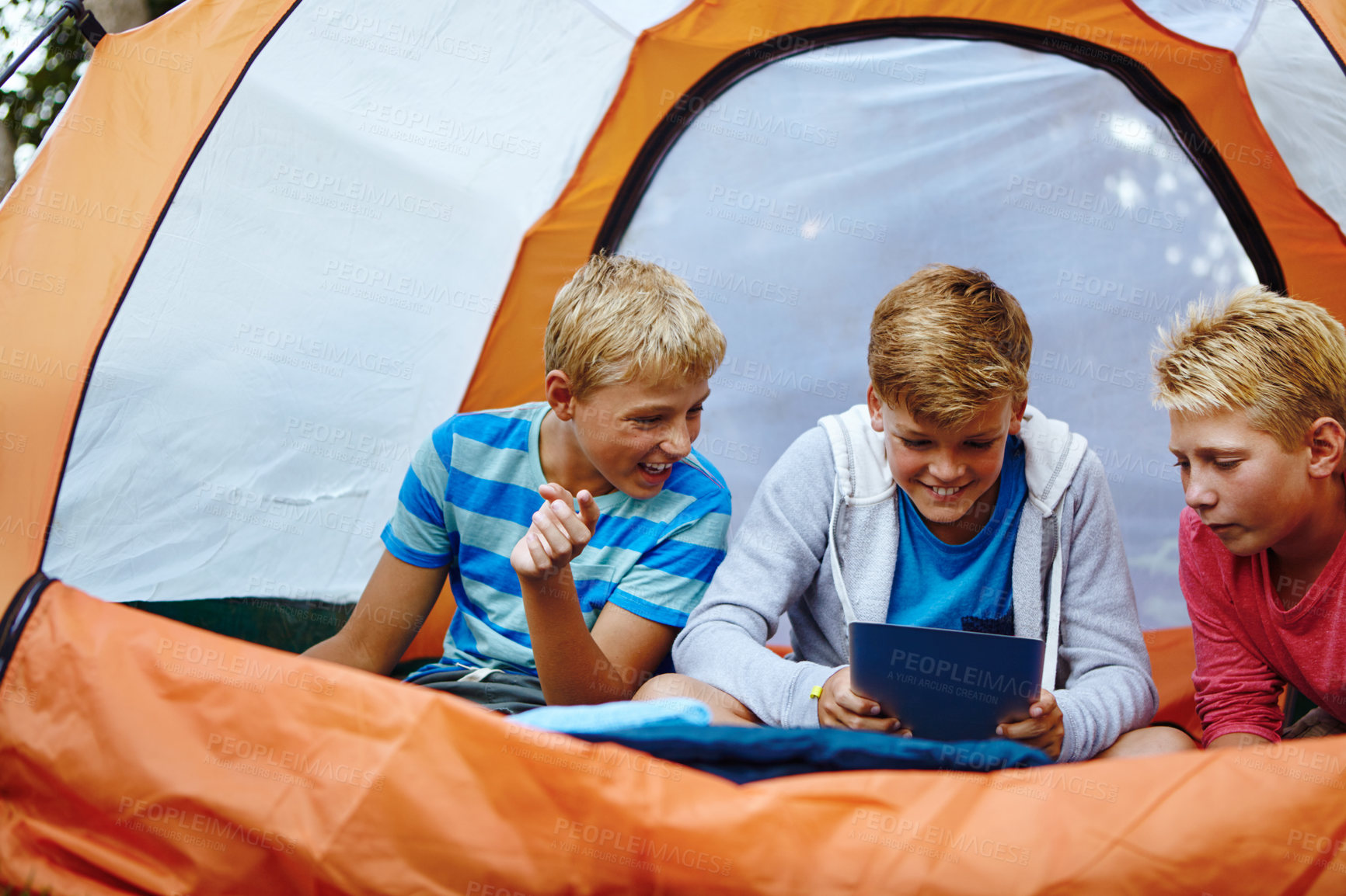Buy stock photo Children, tablet and boys in tent, smile and typing with online game, excited and entertainment. Camping, friends and kids with tech, happiness and internet with fun, bonding together and connection