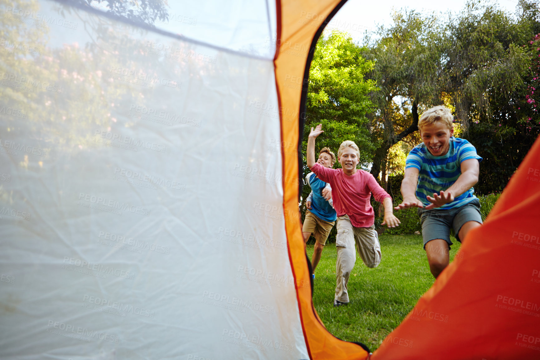 Buy stock photo Full length shot of three young boys running into their tent