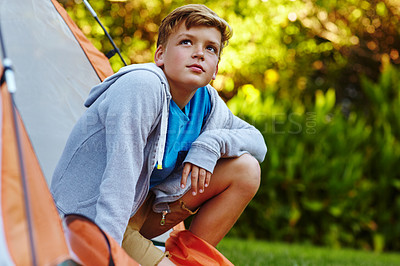 Buy stock photo Cropped shot of a young boy looking out of his tent