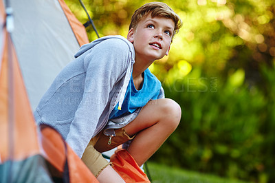 Buy stock photo Cropped shot of a young boy looking out of his tent