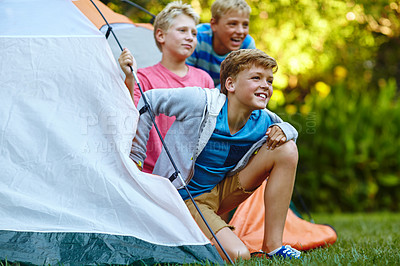 Buy stock photo Cropped shot of three young boys looking out of their tent