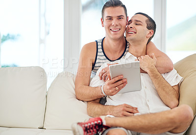 Buy stock photo Gay couple, hug and tablet on sofa for social media, streaming and online shopping in home. Men, portrait and love in living room with technology, connectivity and latest LGBT news on internet