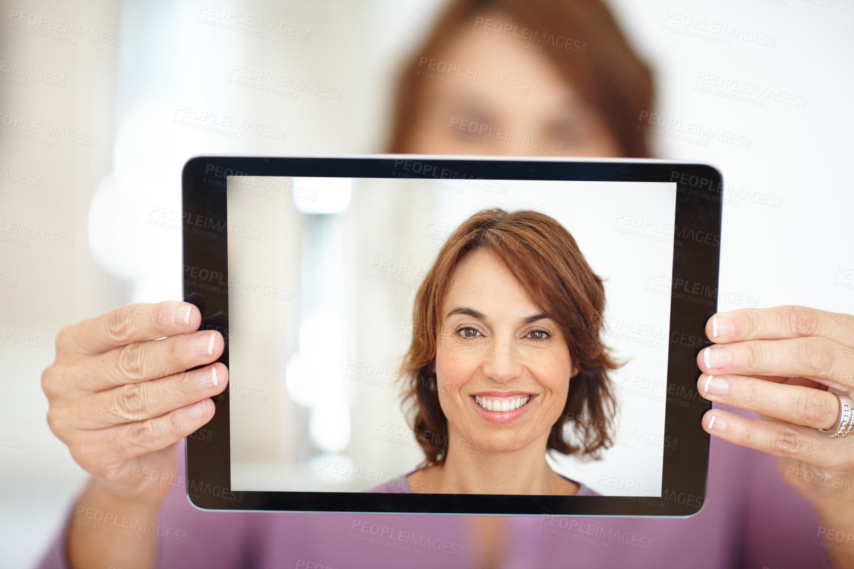 Buy stock photo Shot of a woman taking a selfie on her tablet