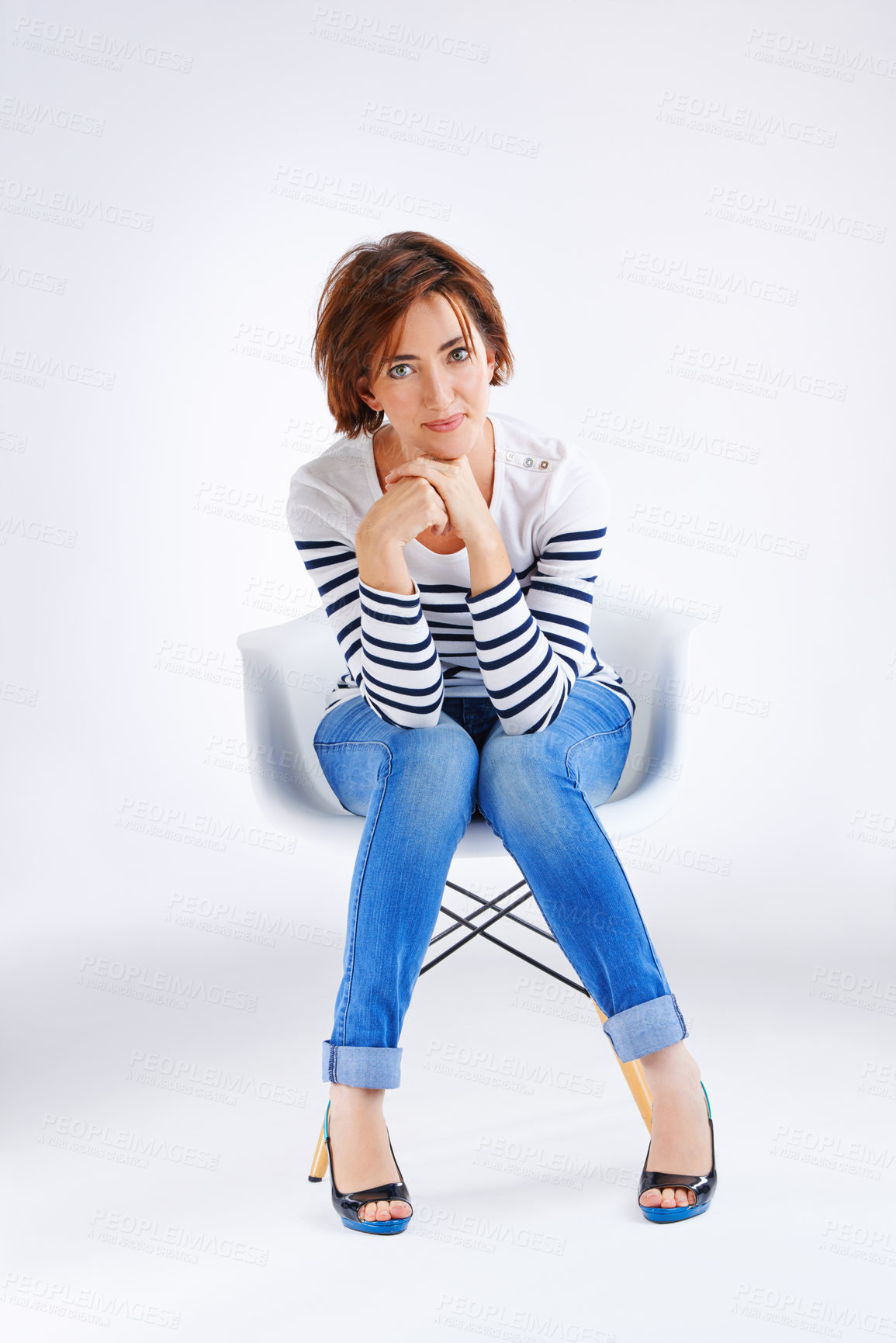 Buy stock photo Studio portrait of a young woman posing against a grey background