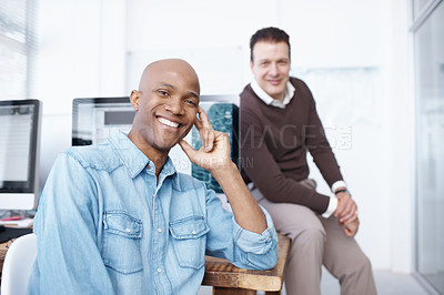 Buy stock photo Portrait of two businesspeople sitting in the office together