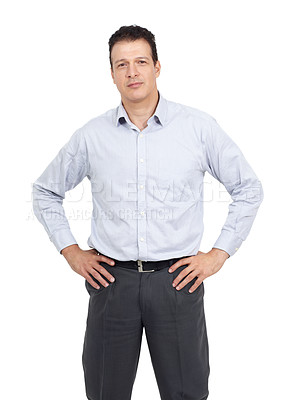 Buy stock photo Studio portrait of a serious-looking man standing with his hands on his hips isolated on white