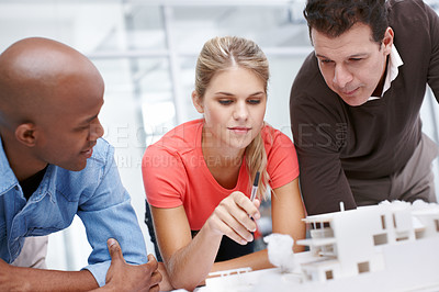 Buy stock photo A team of architects working together on an architectural model
