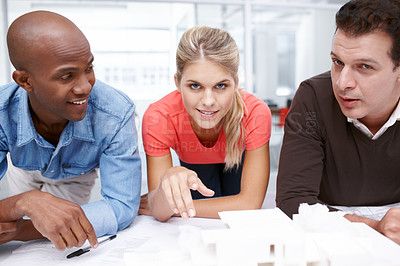 Buy stock photo A team of architects standing by their architectural model
