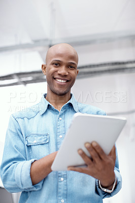 Buy stock photo Portrait of a young businessman working on a digital tablet in the office