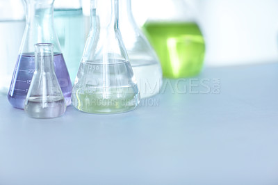 Buy stock photo Glass vials, beakers and flasks filled with colourful liquid samples for testing on a table in a medical laboratory with copyspace. Chemical substances for clinical experiment and forensic research