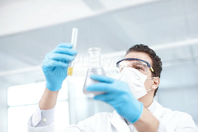 Buy stock photo Low angle shot holding up two vials of chemicals