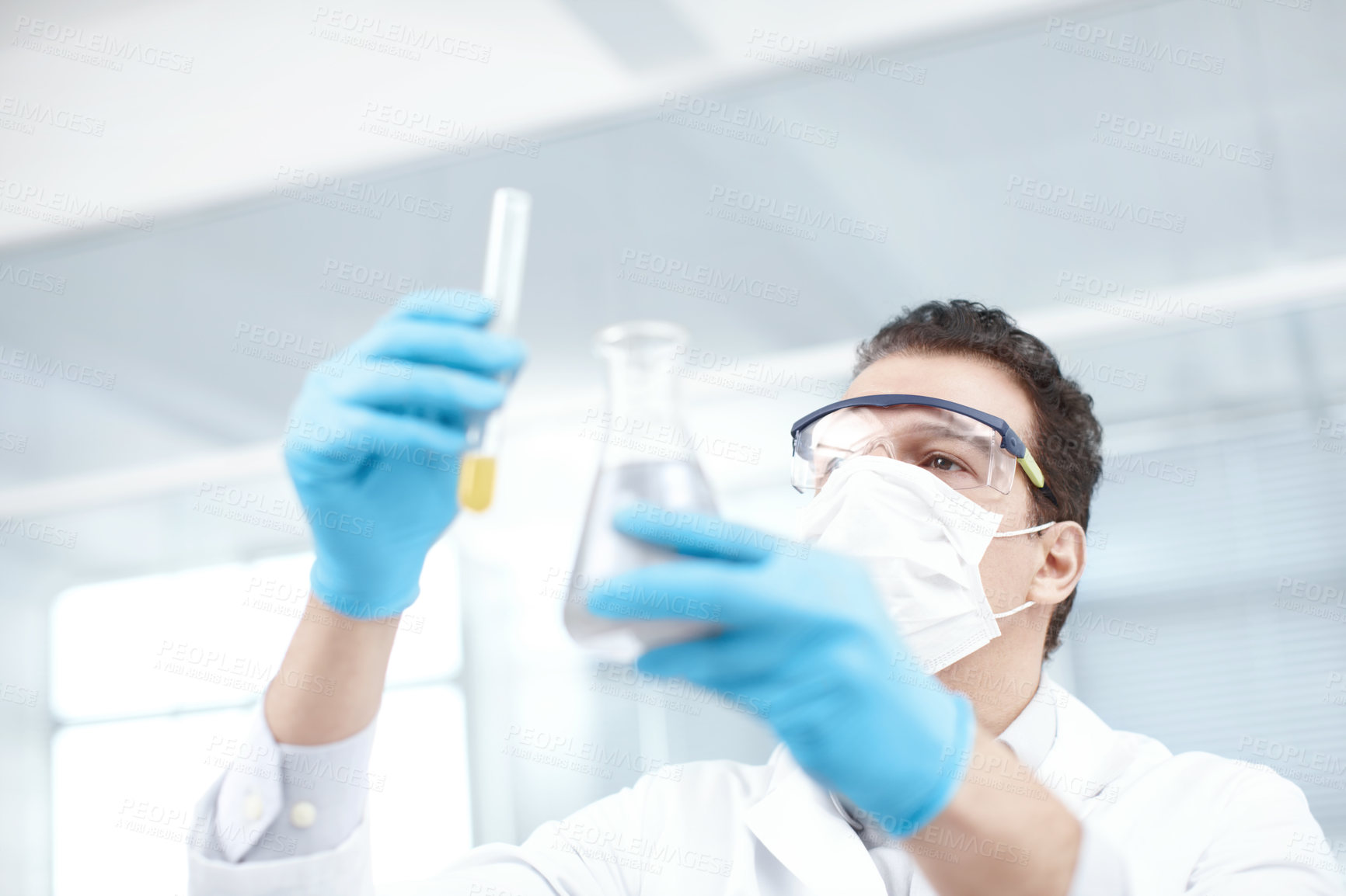 Buy stock photo Man, scientist or face mask with vial or beaker for chemical experiment, test or exam at lab. Male person, chemist or pharmacist with liquid compound, sample or tube for mixture, alchemy or discovery