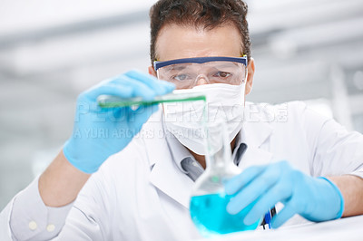 Buy stock photo Closeup of a chemist pouring two chemicals together