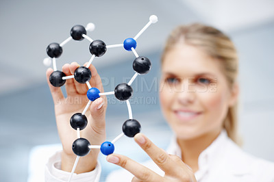 Buy stock photo Closeup of a molecular structure model being held up by a gorgeous female scientist