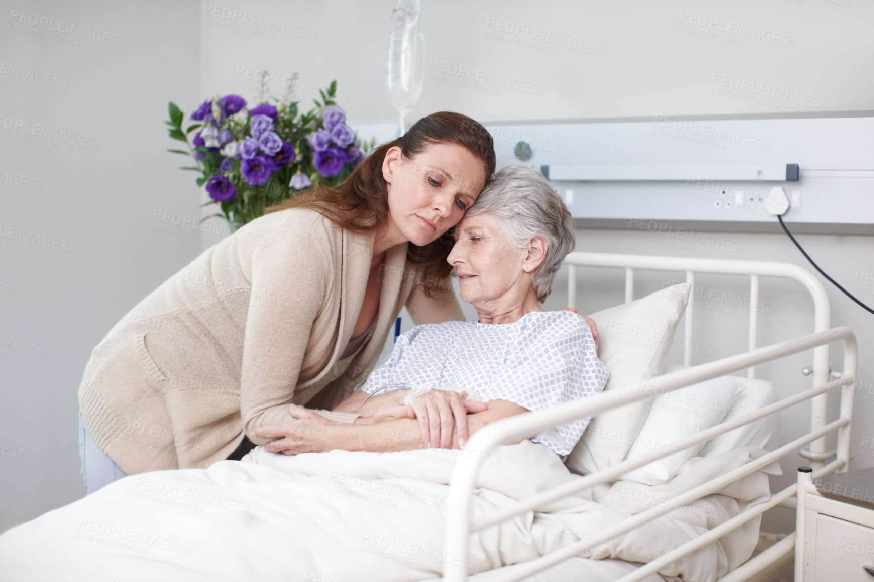 Buy stock photo Elderly woman, daughter and hug in hospital for medical exam, consultation or doctor appointment. Family, senior care and support in clinic for visit, healthcare services or bonding as cancer patient