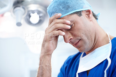 Buy stock photo Close-up of a doctor holding his hand over his face negatively