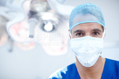 Buy stock photo A doctor wearing full scrubs looking at the camera