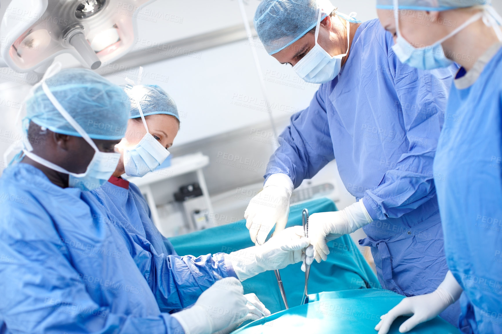 Buy stock photo Surgeon, teamwork and doctors in operating room together for emergency medical treatment in hospital. People, surgery and nurses in theater with equipment, healthcare and group support in trauma unit