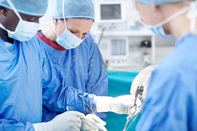 Buy stock photo Surgical doctors working together as a team during a surgery
