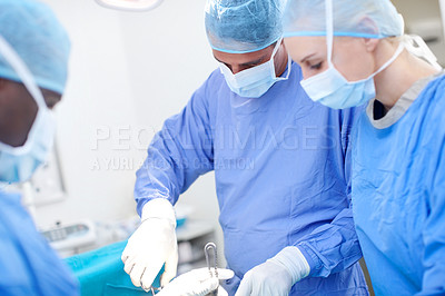 Buy stock photo Surgeons working together operating on a patient in surgery
