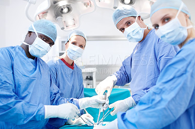Buy stock photo Portrait of a surgical team of doctors operating in theatre