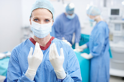 Buy stock photo Woman, gloves or surgeon in portrait for surgery, emergency accident or healthcare in hospital theater. Mask, face or doctors in surgical gear in operating room for medical safety, operation or help