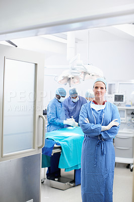 Buy stock photo Woman, surgeon and confident in hospital for healthcare, operation and team for service. Doctor portrait, medical professionals and arms crossed in theater for procedure, surgery and PPE for safety