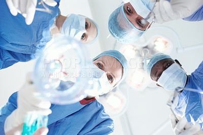 Buy stock photo Patient's view of medical surgeons and doctors putting a patient under a general anaesthetic