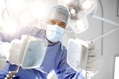 Buy stock photo Patient's view of a doctor trying to resuscitate him/her with a defibrillator
