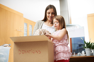 Buy stock photo A young girl helping her mother with some charity work