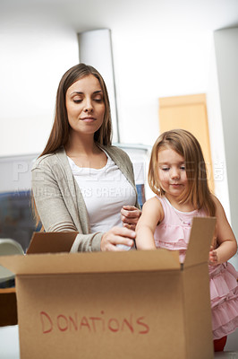 Buy stock photo Mother, child and helping with box for donation charity support, community service and volunteer project. Family, woman and girl with cardboard for giving process, poor outreach and bonding at house