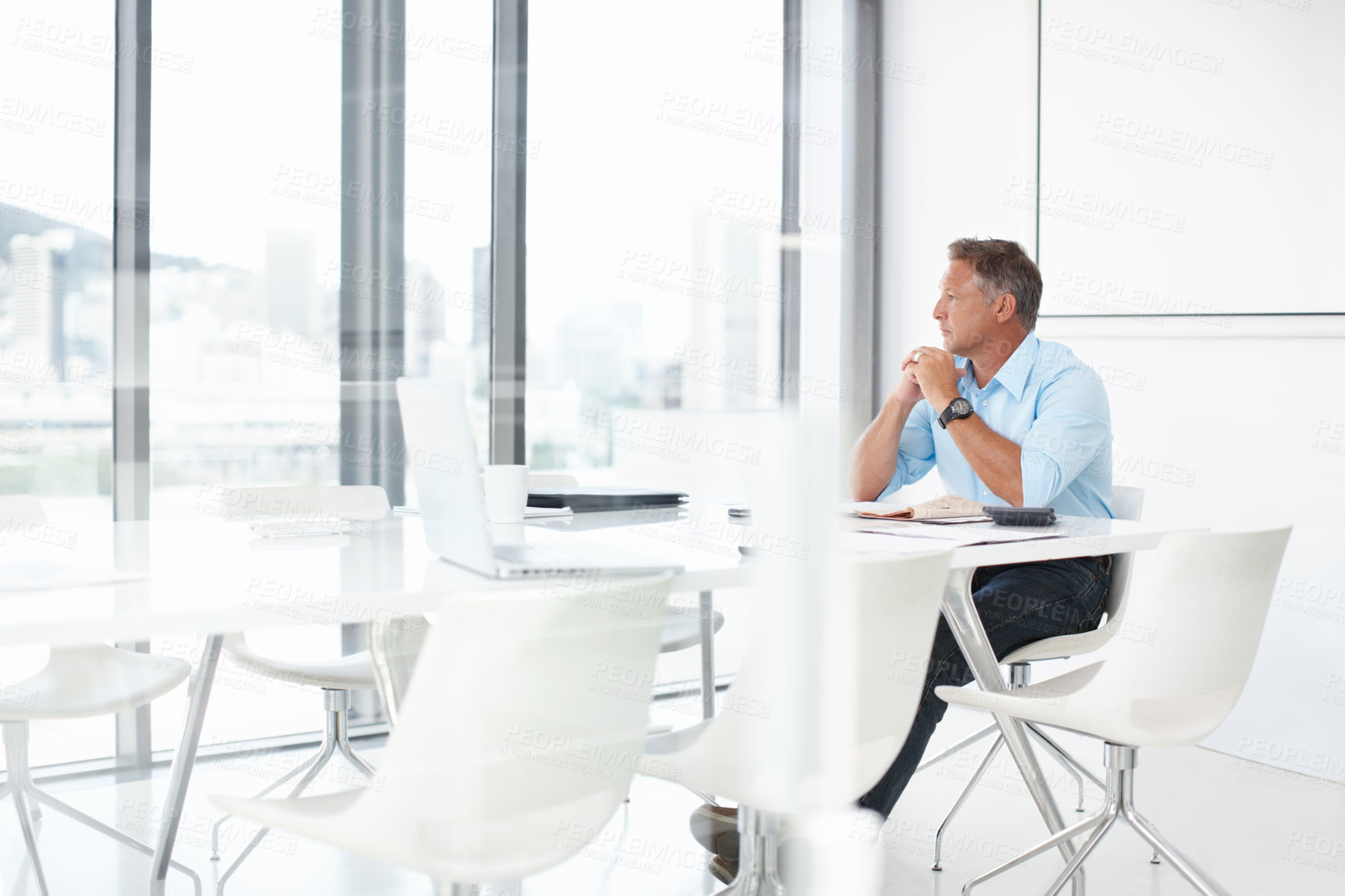 Buy stock photo A mature advertising executive looking thoughtfully out of the window of the boardroom